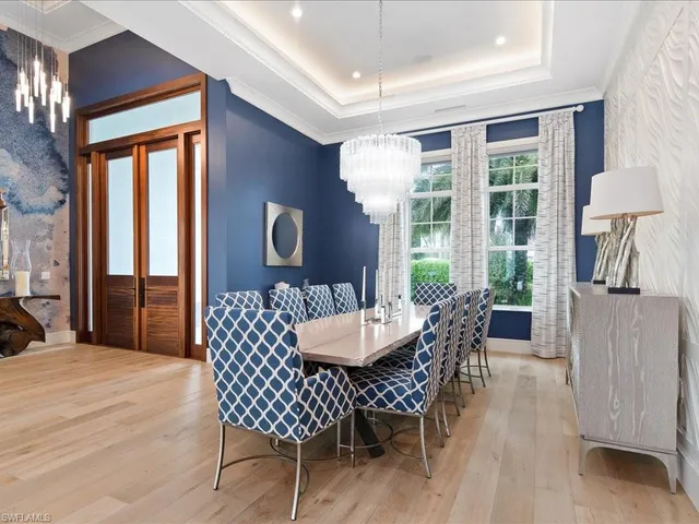 a dining room with furniture window and wooden floor