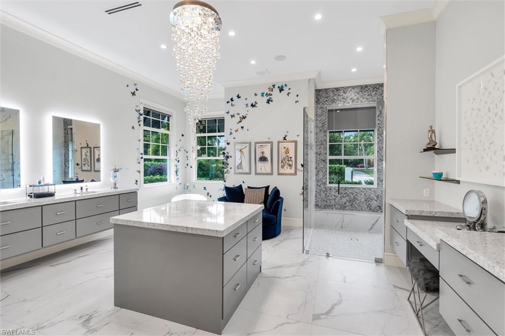 830 Cassena Road Naples, FL 34108 - Photo 10 of 41 a large white bathroom with a large tub sink shower and mirror