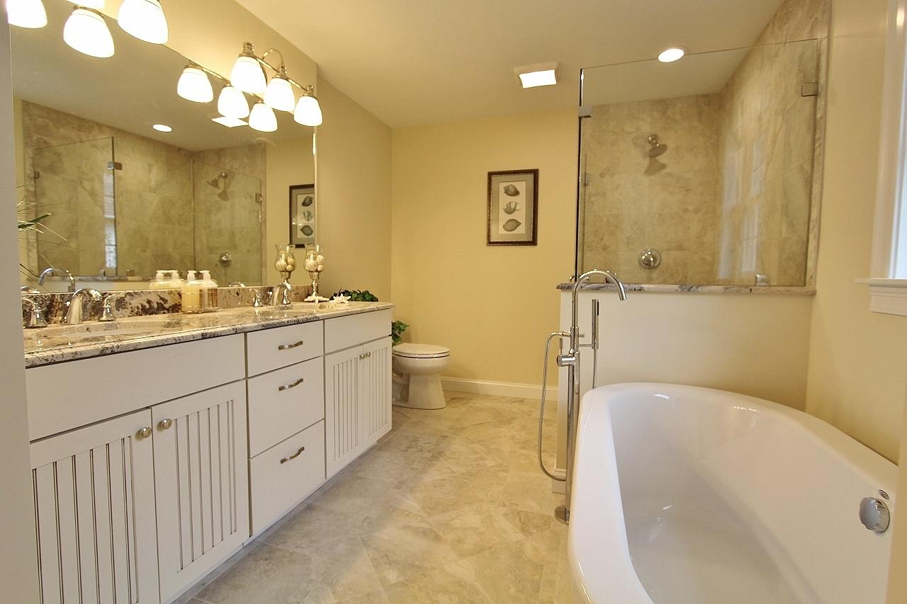 61 Blue Castle Drive Mashpee, MA 02649 - Photo 26 of 28 a spacious bathroom with a double vanity sink toilet mirror and bathtub