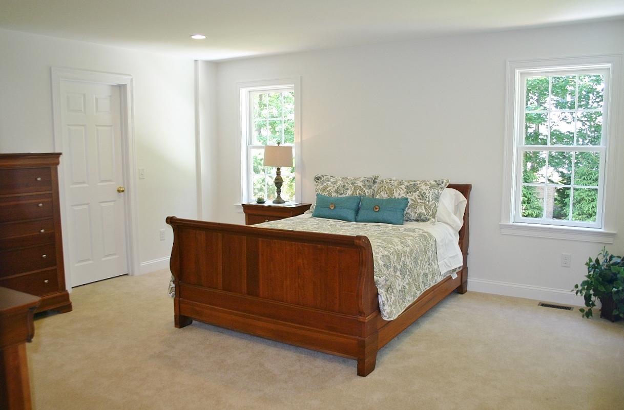 61 Blue Castle Drive Mashpee, MA 02649 - Photo 28 of 28 a bed sitting in a bedroom next to a window