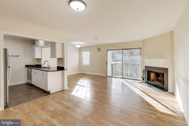 a kitchen with granite countertop a stove top oven sink and cabinets