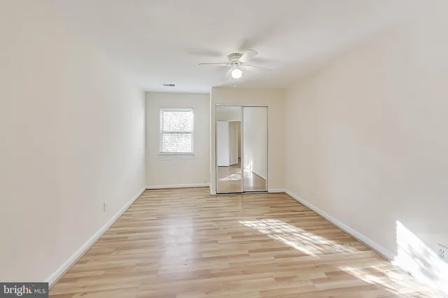 a view of a room with wooden floor and cabinet