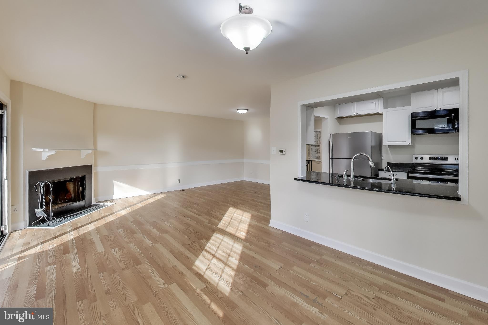 10408 Parthenon Court, Unit 10408 Bethesda, MD 20817 - Photo 3 of 34 a view of a livingroom with a fireplace a sink and a window