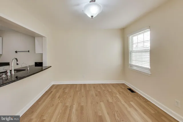 a view of a kitchen with a sink and refrigerator