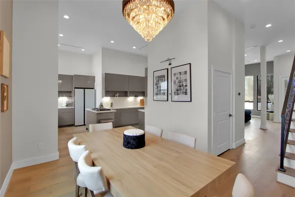 a view of a dining room with furniture and a chandelier