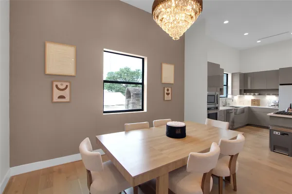 a view of a dining room with furniture and a chandelier