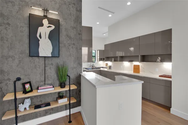 a kitchen with stainless steel appliances granite countertop a sink a stove and a wooden floors