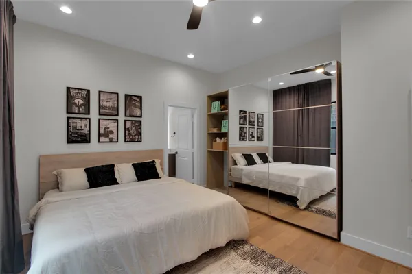 a bedroom with a large bed and a chandelier