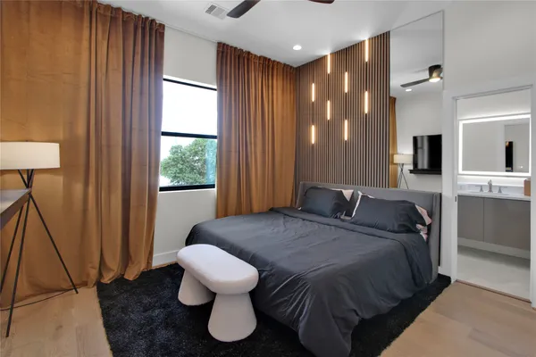 a spacious bedroom with a bed and a table