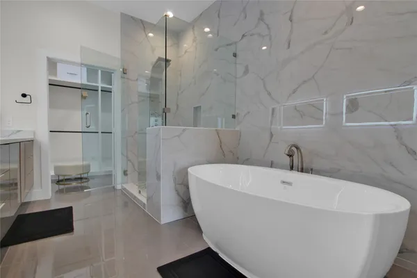 a bathroom with a bathtub and a shower