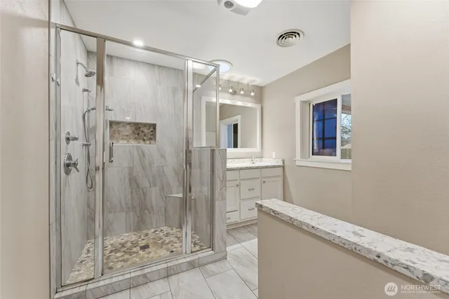 a bathroom with a shower and a sink