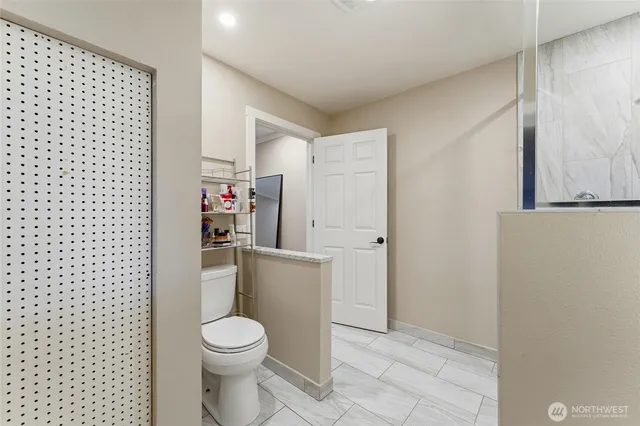 a white toilet sitting next to a shower curtain