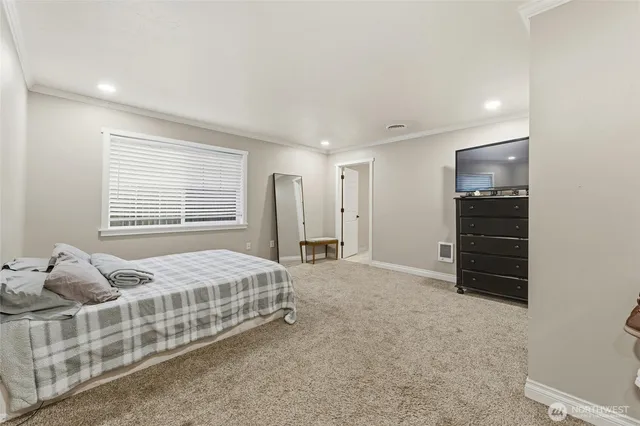 a bedroom with bed and a window