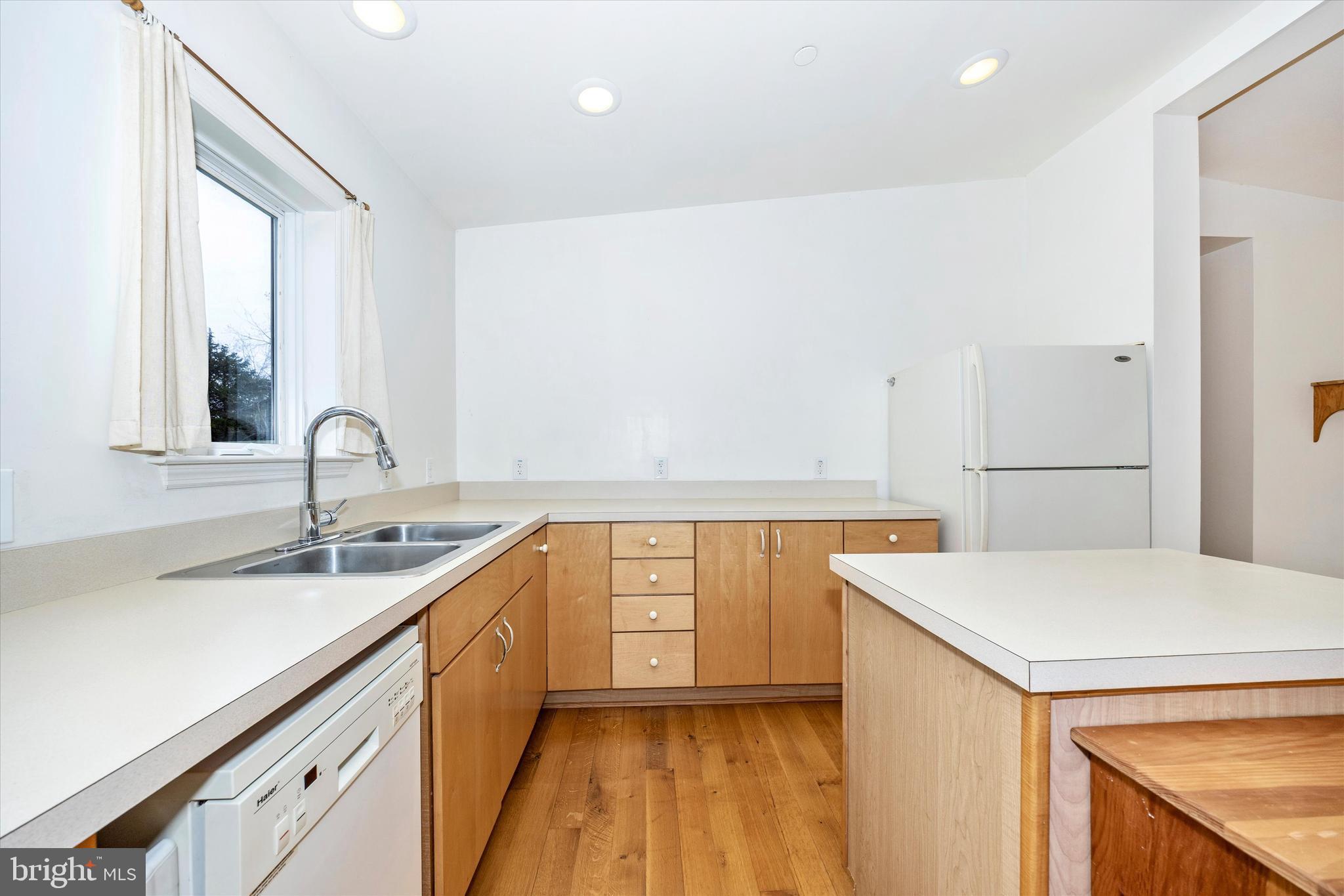 9930 Woodsboro Road Frederick, MD 21701 - Photo 14 of 58 a kitchen with a sink cabinets and wooden floor