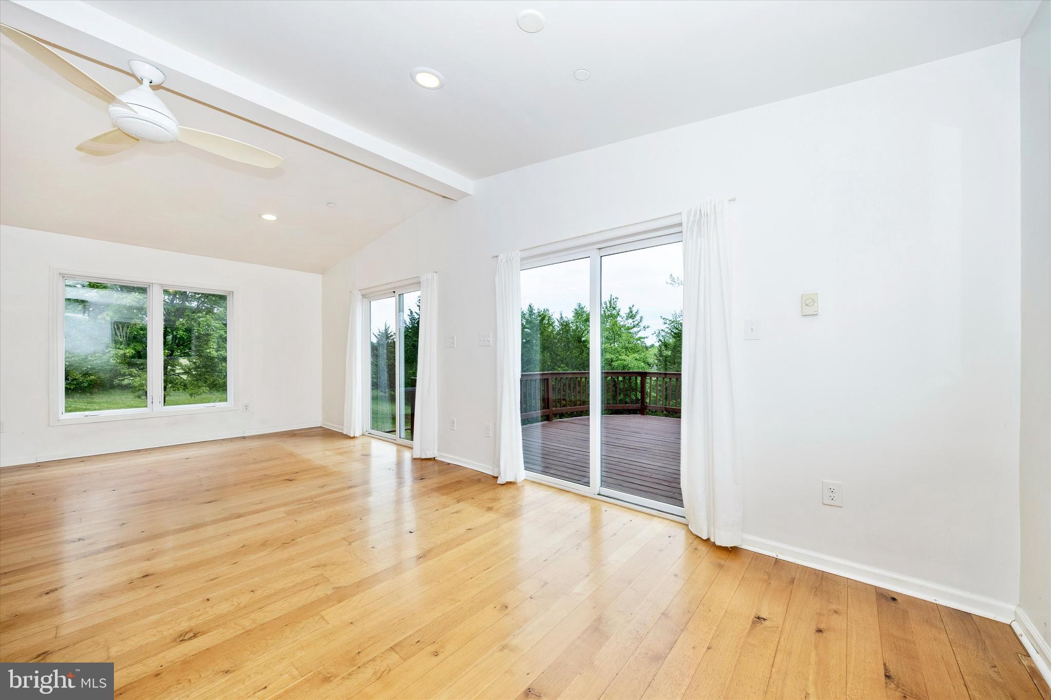 9930 Woodsboro Road Frederick, MD 21701 - Photo 19 of 58 an empty room with wooden floor and windows