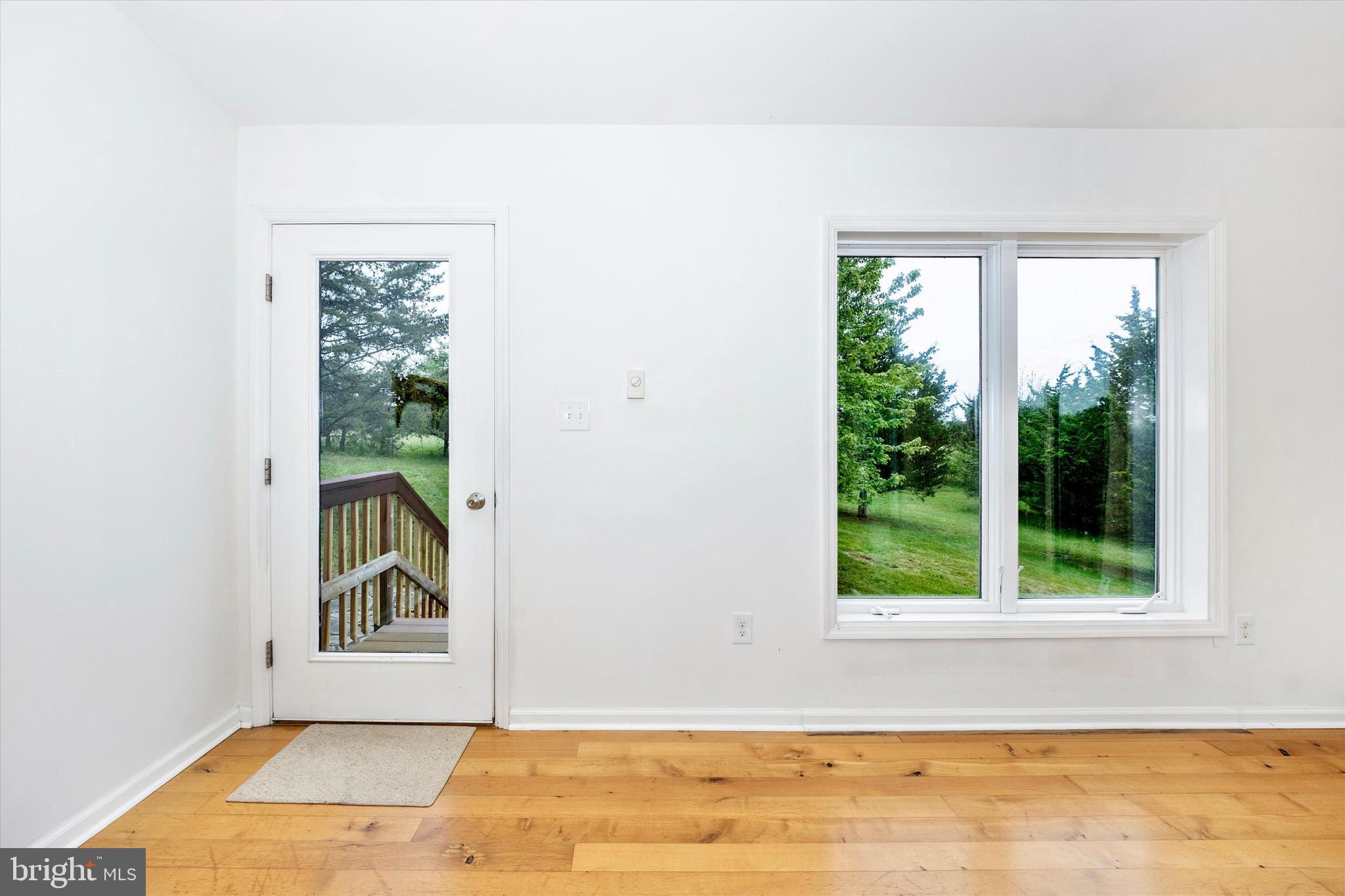 9930 Woodsboro Road Frederick, MD 21701 - Photo 3 of 58 a view of a room that has a window and wooden floor