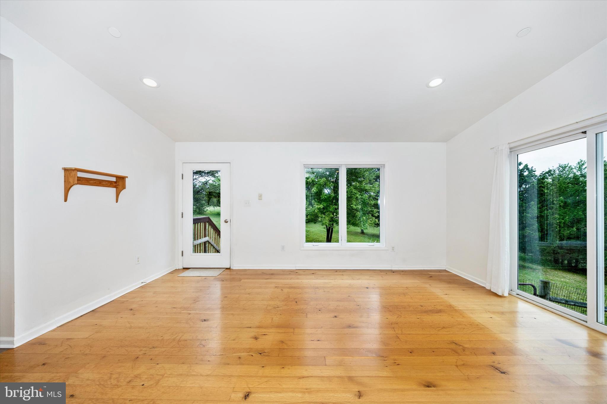9930 Woodsboro Road Frederick, MD 21701 - Photo 7 of 58 a view of empty room with wooden floor and fan