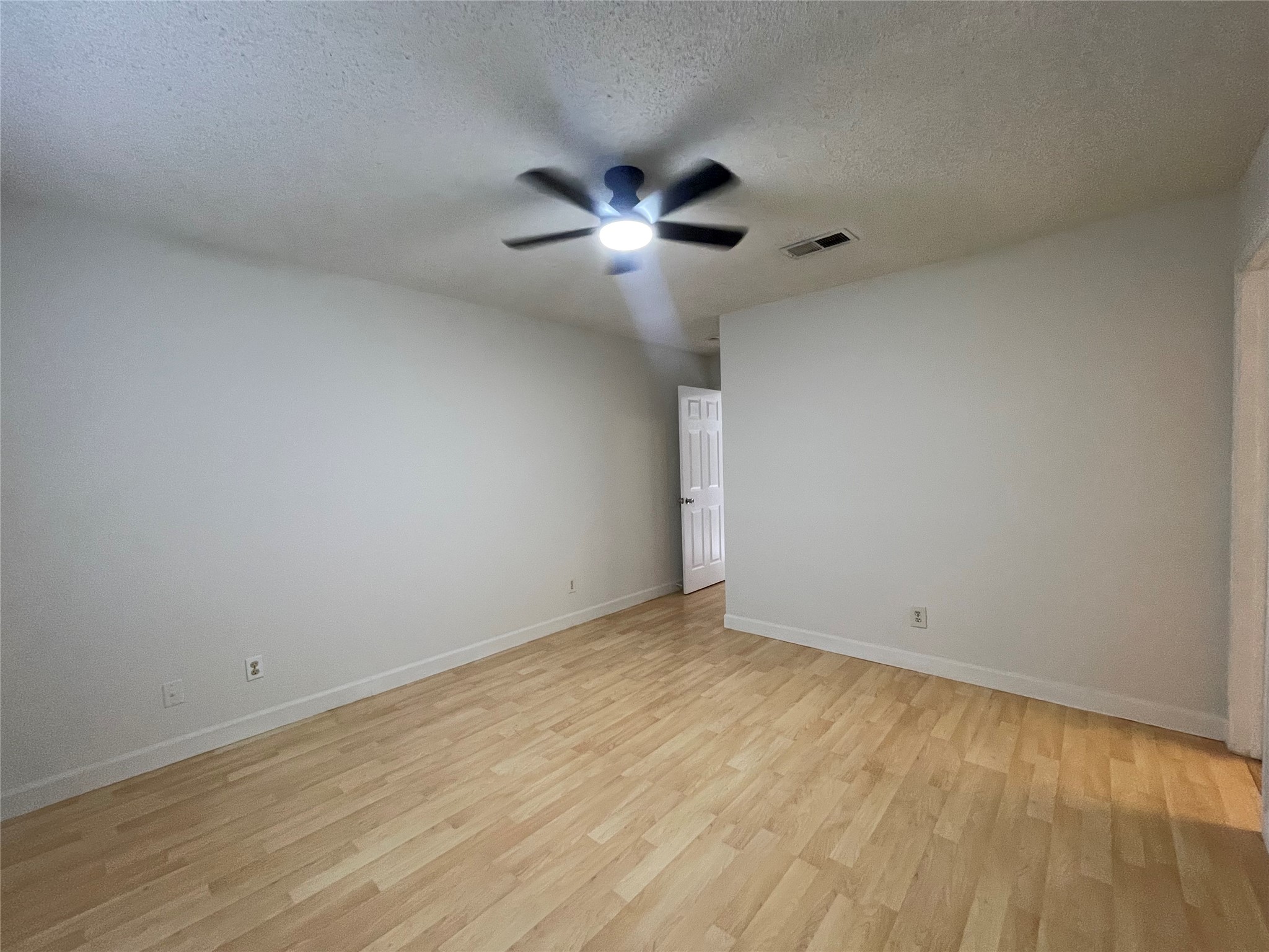2031 Redwing Way Round Rock, TX 78664 - Photo 7 of 25 Laminate floors create a welcoming atmosphere in this comfortable living space.