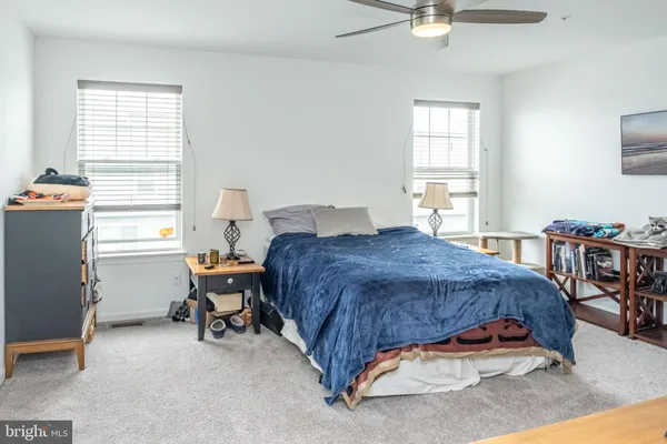 a spacious bedroom with a bed and a table in it