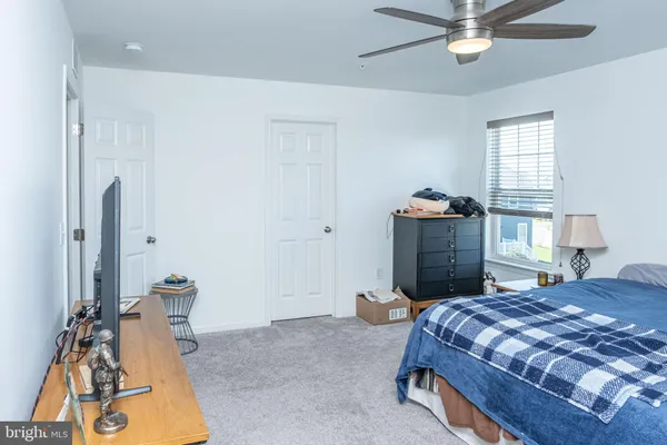 a bedroom with a bed and dresser