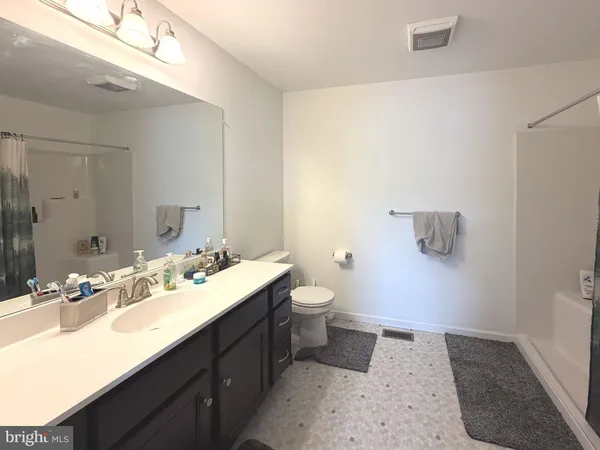 a bathroom with a sink a toilet and mirror