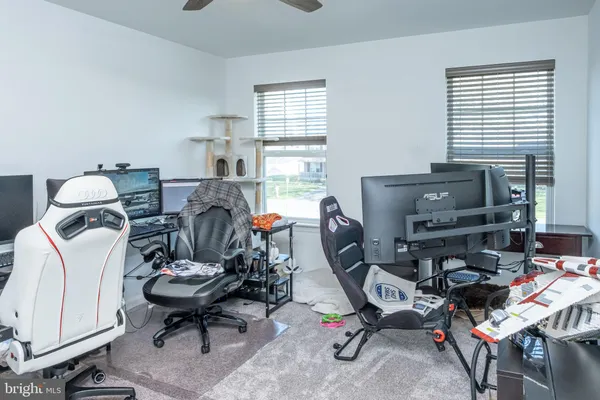 a view of a workspace with furniture and a window