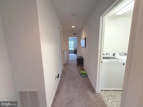 a view of a hallway with wooden shelves