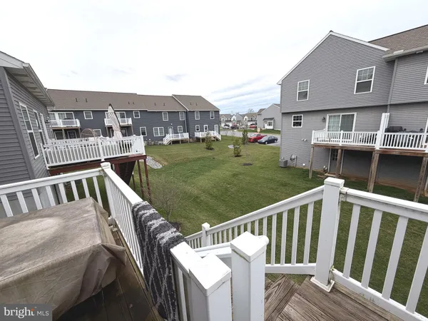 a view of a house with backyard and deck