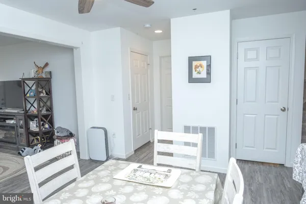 a view of a livingroom with wooden floor and a window