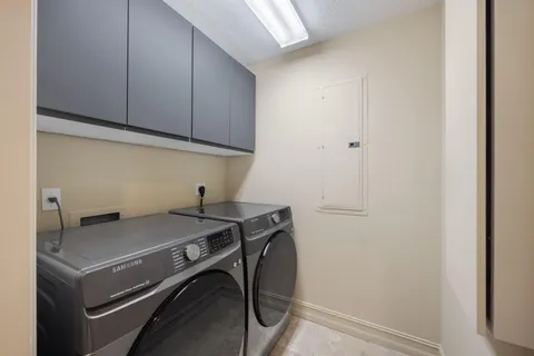 a view of a storage and utility room with washer and dryer