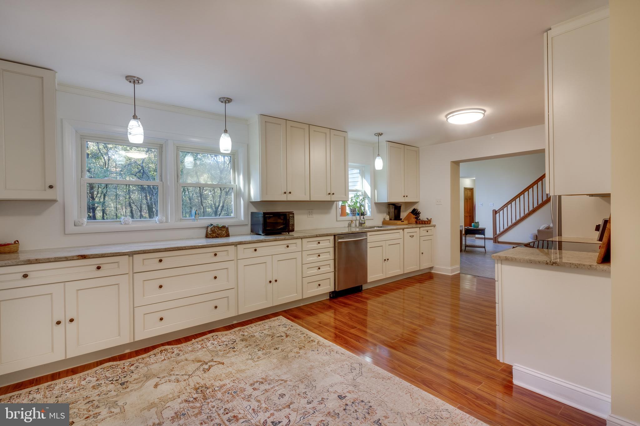 83 Grassy Lake Road Shamong, NJ 08088 - Photo 1 of 48 a large white kitchen with wooden floors and stainless steel appliances