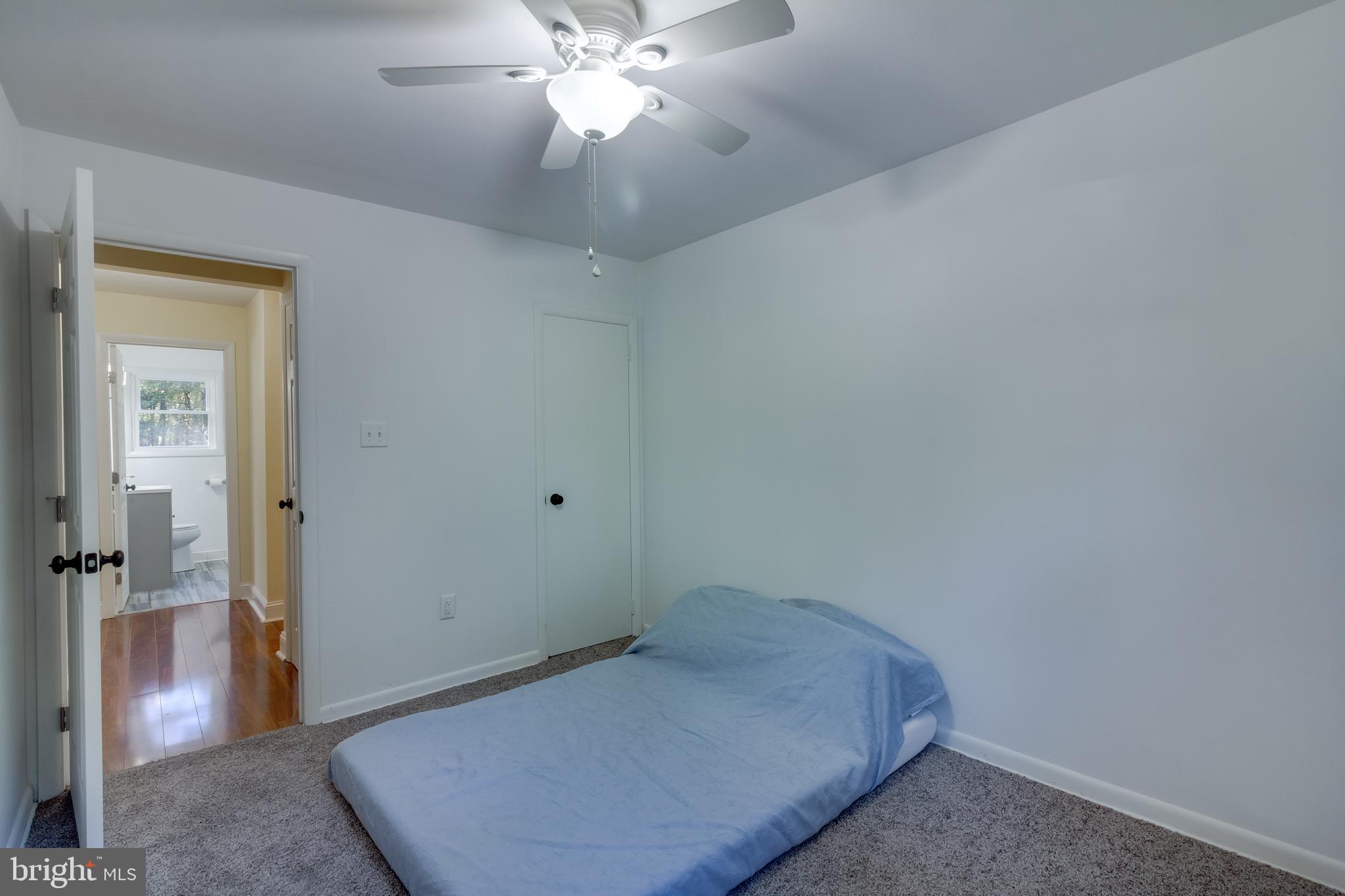 83 Grassy Lake Road Shamong, NJ 08088 - Photo 18 of 48 a bedroom with a bed and a chandelier fan