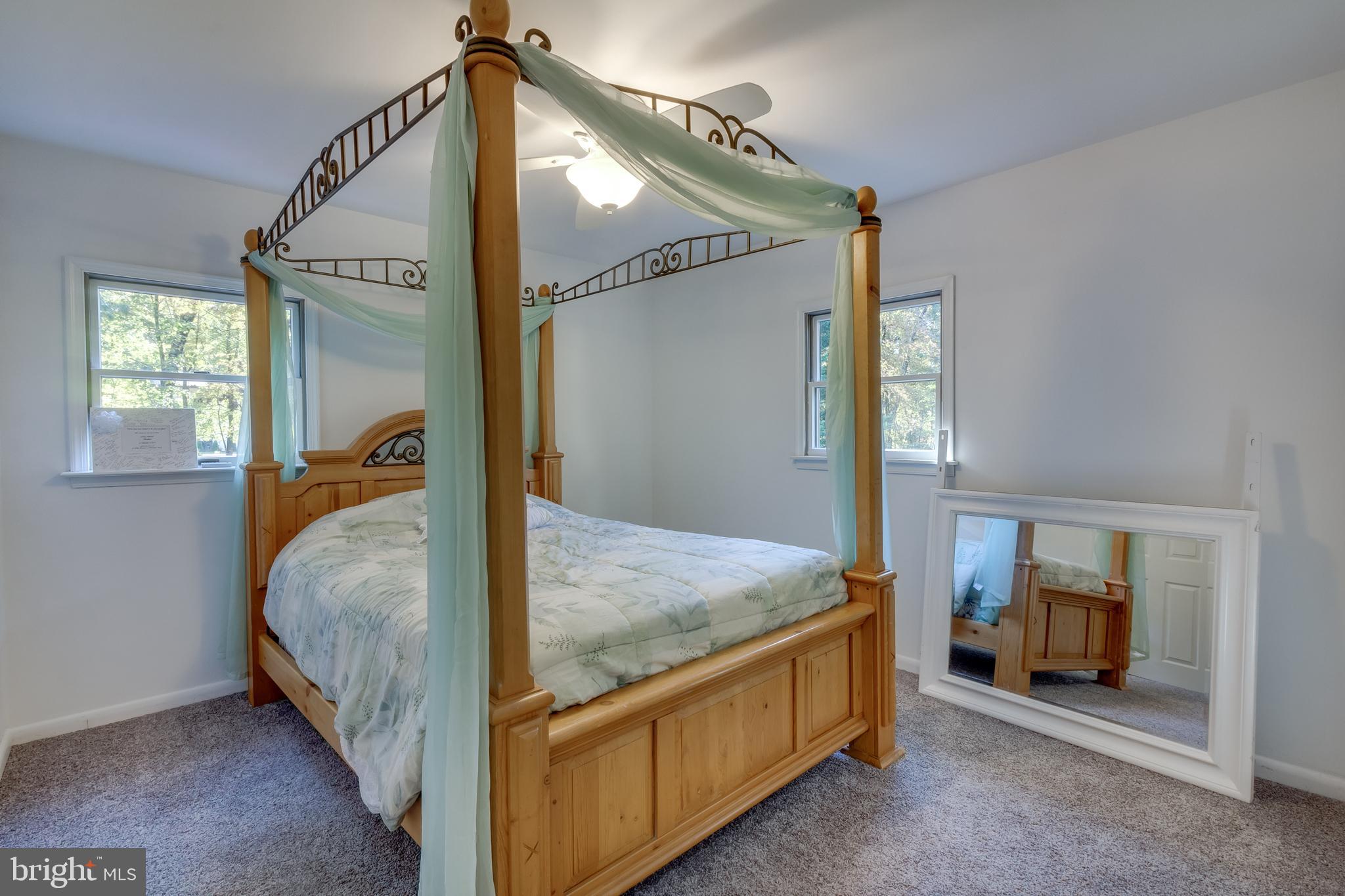83 Grassy Lake Road Shamong, NJ 08088 - Photo 21 of 48 a bed room with a bed and a mirror