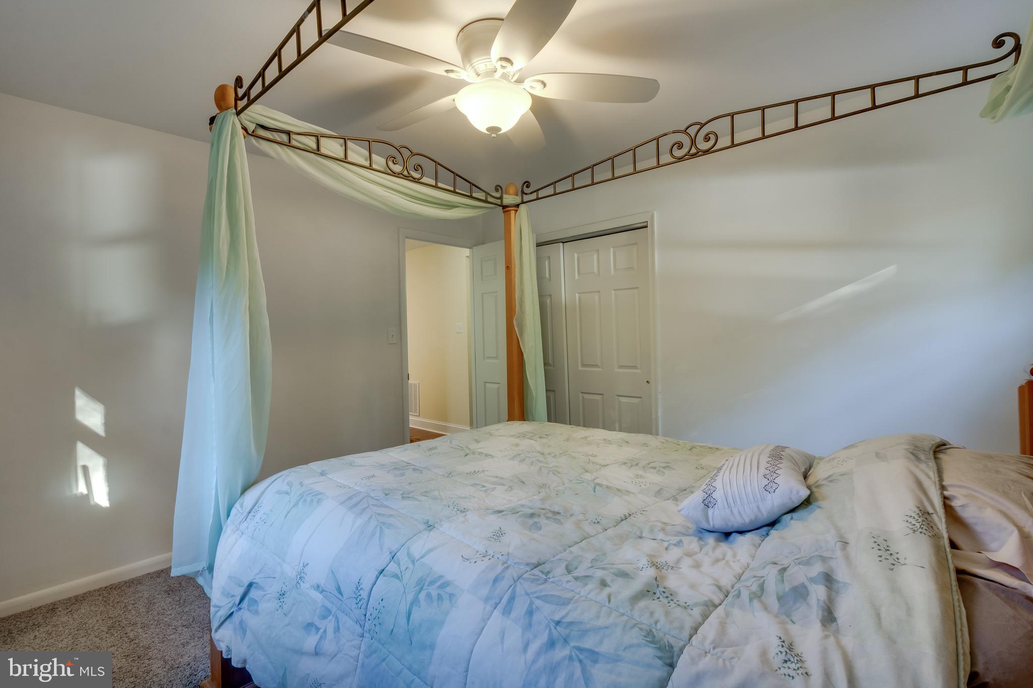 83 Grassy Lake Road Shamong, NJ 08088 - Photo 22 of 48 a bedroom with a bed and a chandelier