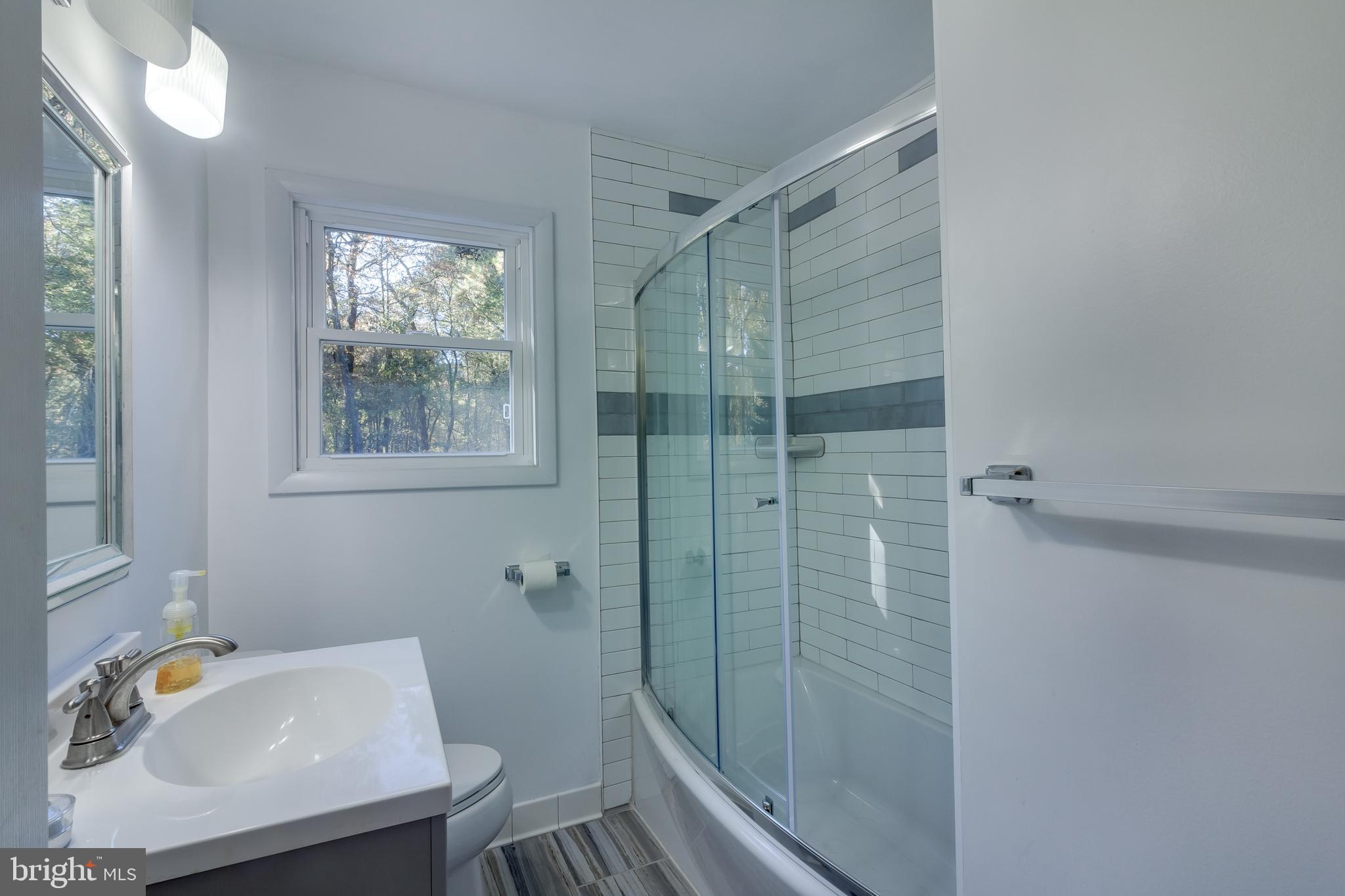 83 Grassy Lake Road Shamong, NJ 08088 - Photo 23 of 48 a bathroom with a sink toilet and shower