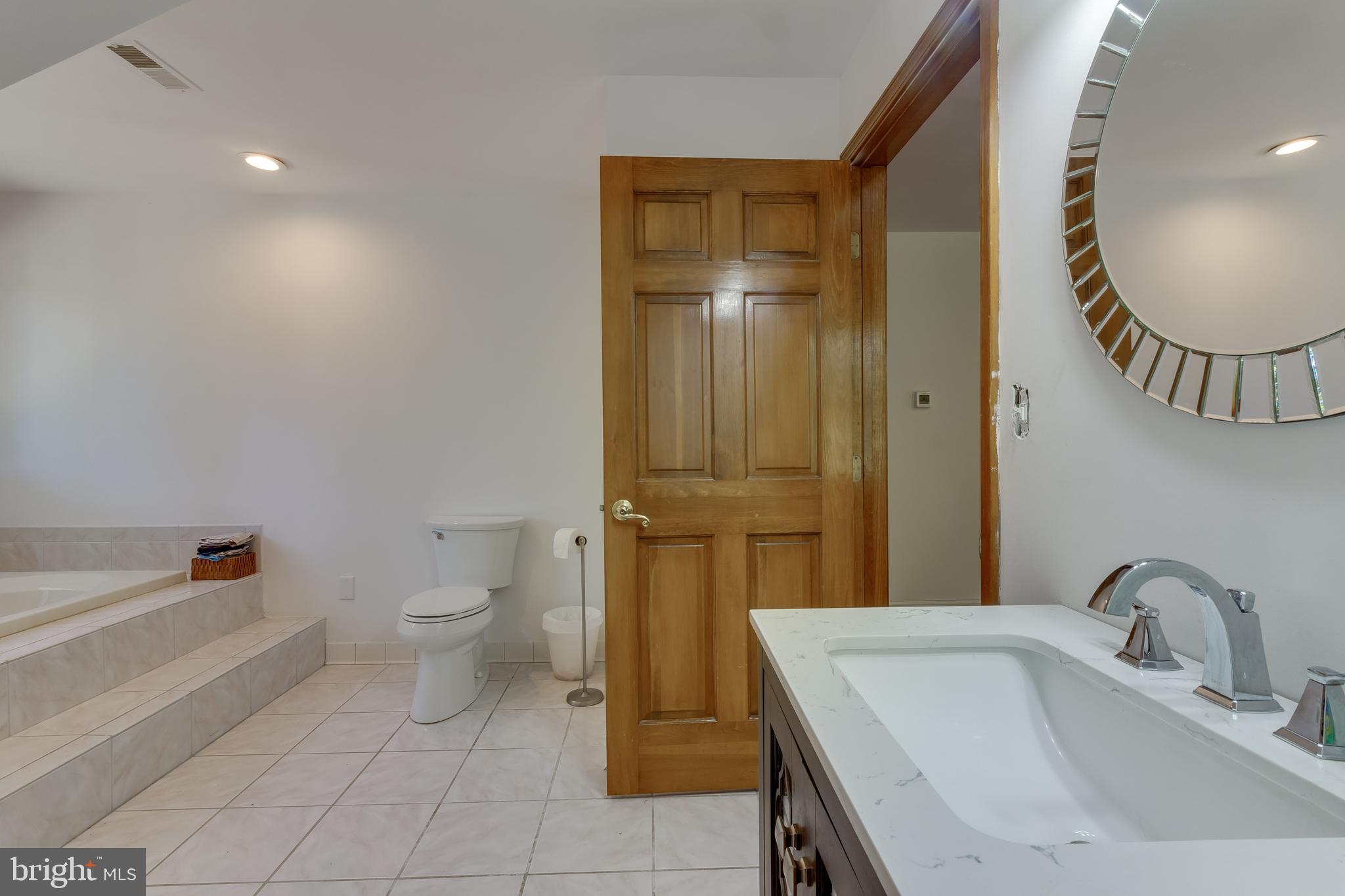 83 Grassy Lake Road Shamong, NJ 08088 - Photo 26 of 48 a bathroom with a sink a toilet and a mirror