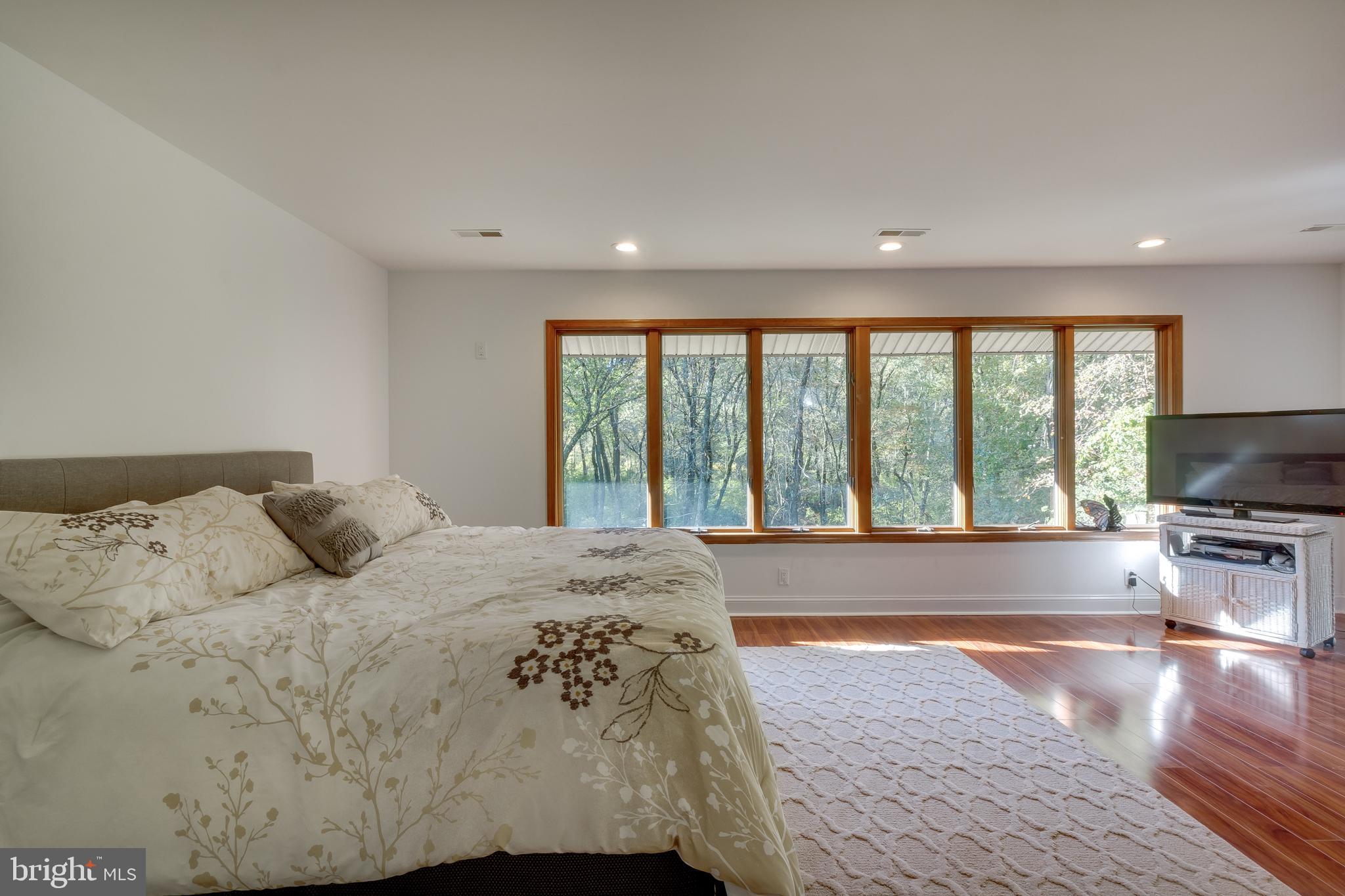 83 Grassy Lake Road Shamong, NJ 08088 - Photo 31 of 48 a bedroom with a large bed and a large window