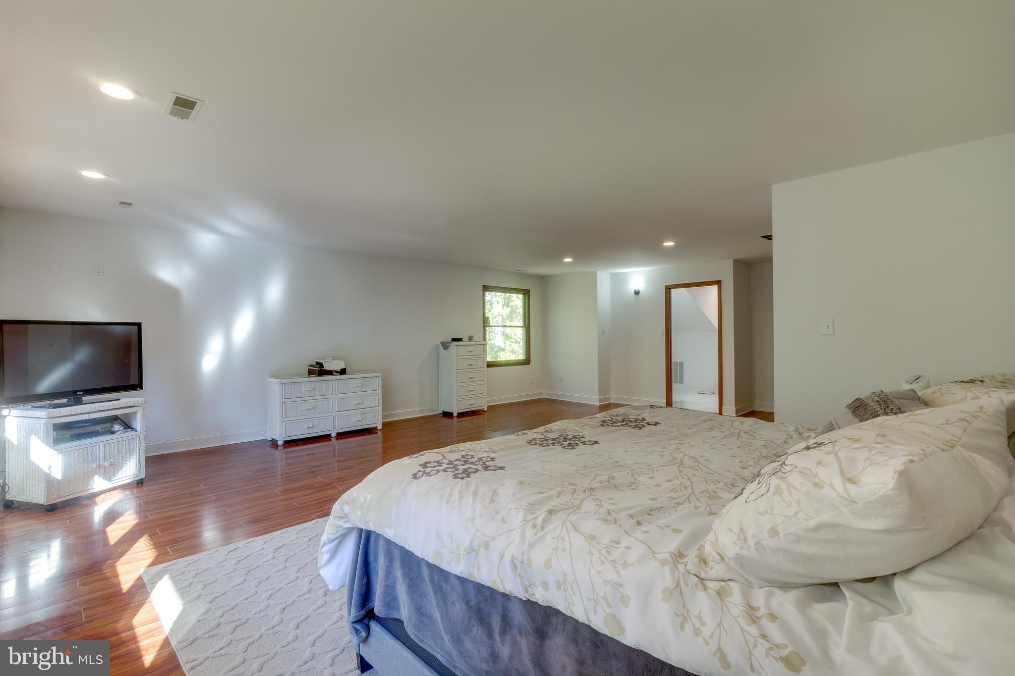 83 Grassy Lake Road Shamong, NJ 08088 - Photo 32 of 48 a spacious bedroom with a bed and a flat screen tv