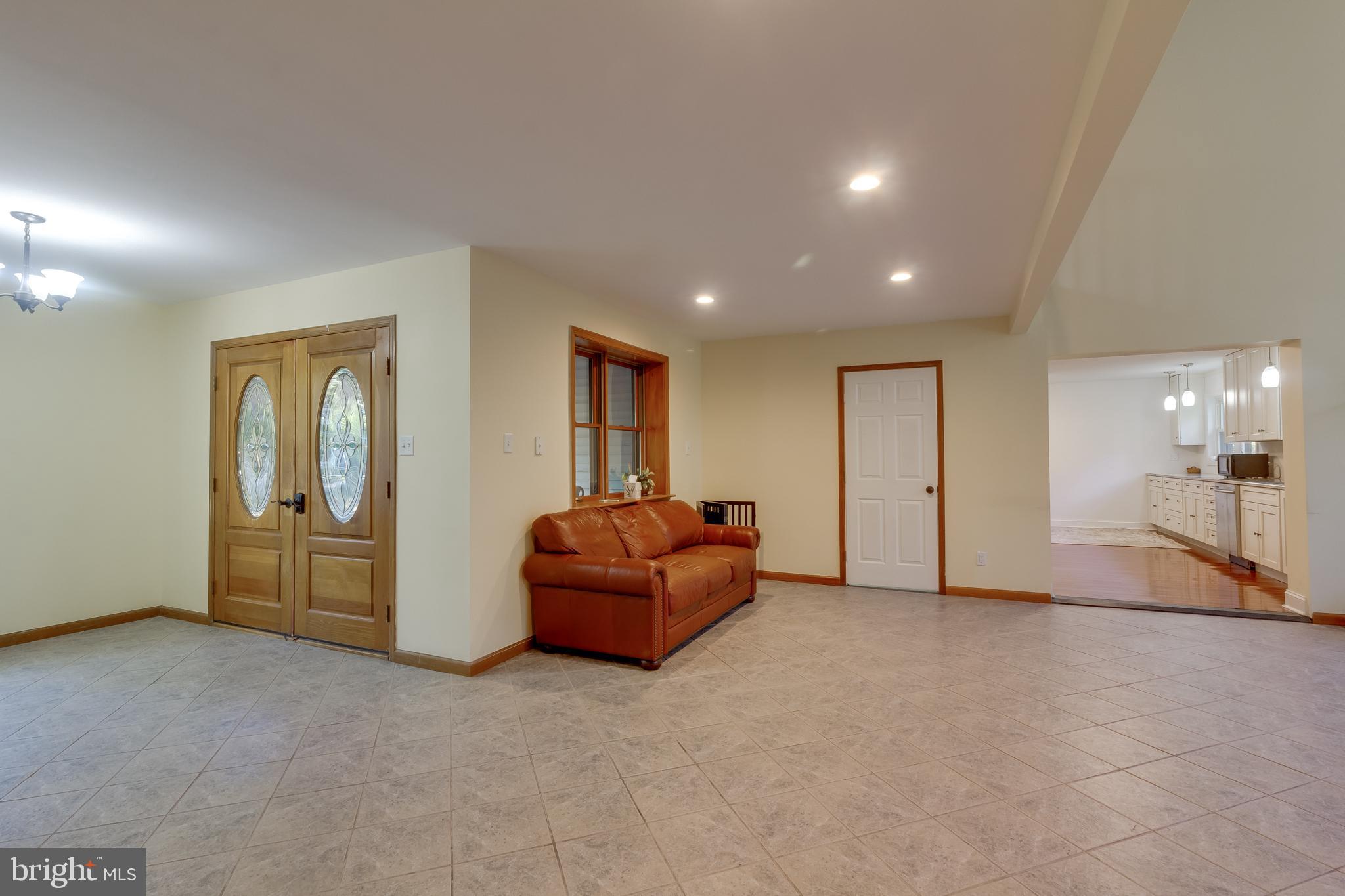83 Grassy Lake Road Shamong, NJ 08088 - Photo 9 of 48 a living room with furniture and a floor to ceiling window
