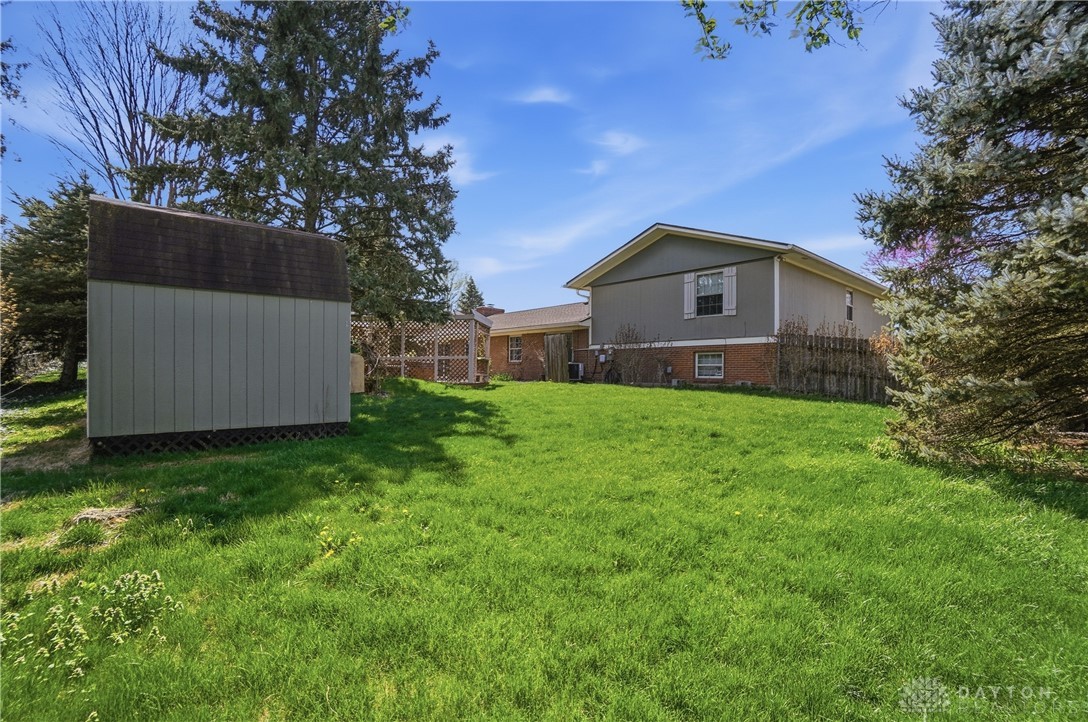 9964 Hummingbird Way Dayton, OH 45458 - Photo 54 of 57 This spacious yard offers ample green space and a convenient shed for all your outdoor needs.