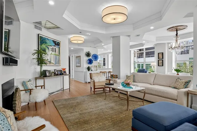 a living room with furniture a rug and a large window