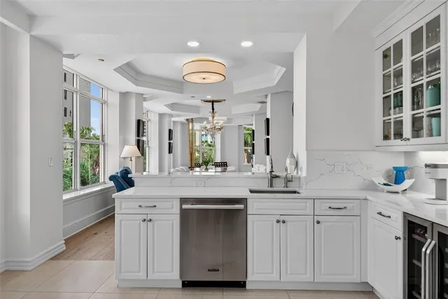 a kitchen with kitchen island granite countertop a stove and a sink