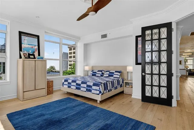 a kitchen with white cabinets and black appliances