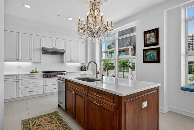 a kitchen with white cabinets and appliances
