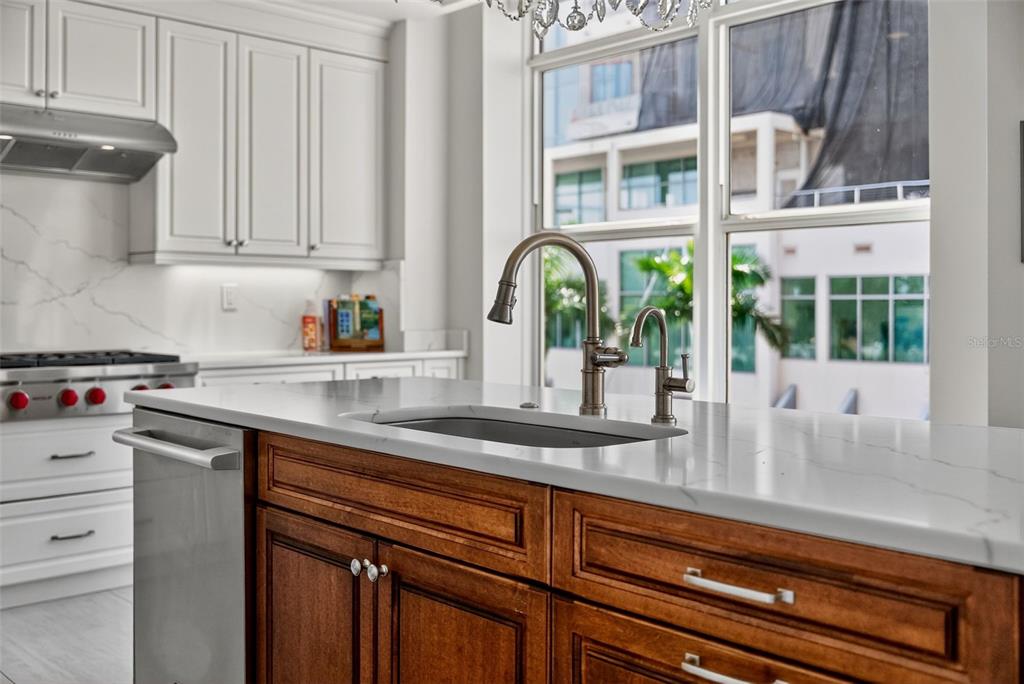 1330 Main Street, Unit 3 Sarasota, FL 34236 - Photo 24 of 73 a kitchen with stainless steel appliances granite countertop a sink and cabinets
