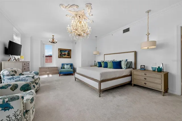 a bed room with a bed and a chandelier
