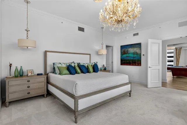 a bedroom with a bed and a chandelier