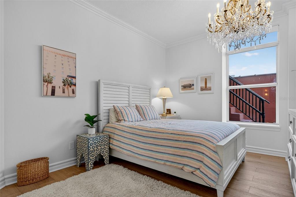 1330 Main Street, Unit 3 Sarasota, FL 34236 - Photo 43 of 73 a bedroom with a bed and a chandelier