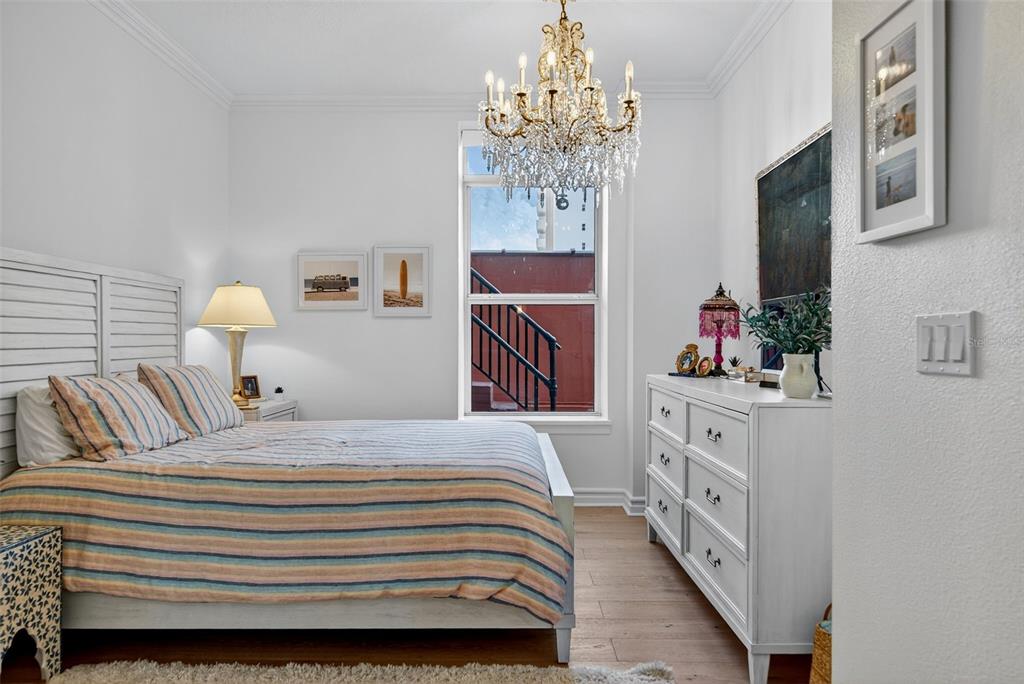 1330 Main Street, Unit 3 Sarasota, FL 34236 - Photo 44 of 73 a bedroom with a bed and a chandelier