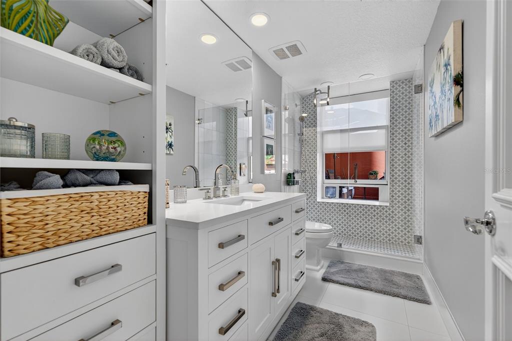 1330 Main Street, Unit 3 Sarasota, FL 34236 - Photo 47 of 73 a bathroom with a granite countertop double vanity sink mirror bathtub and toilet